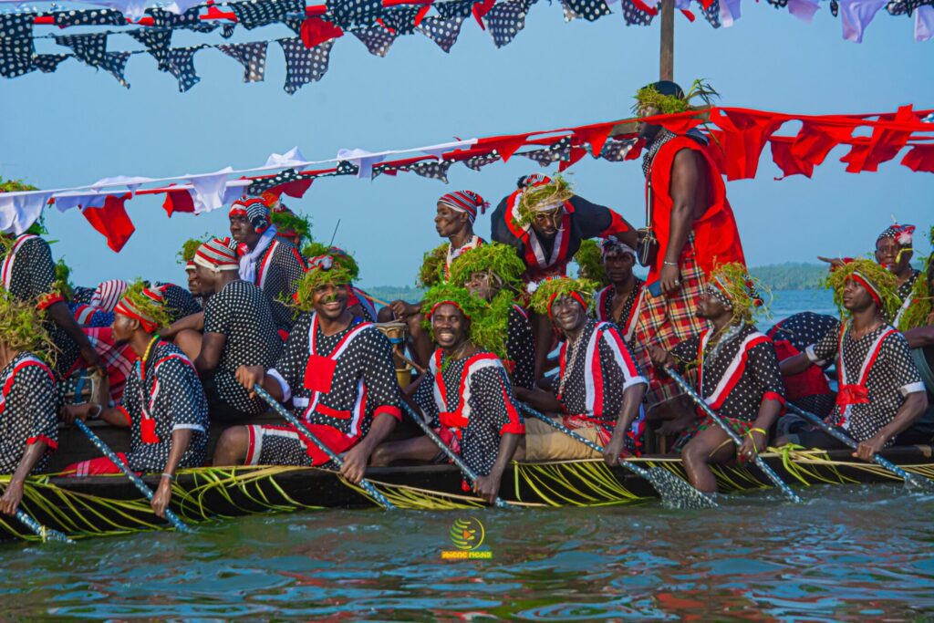 SparkBayelsa - Colorful canoe festival on water.