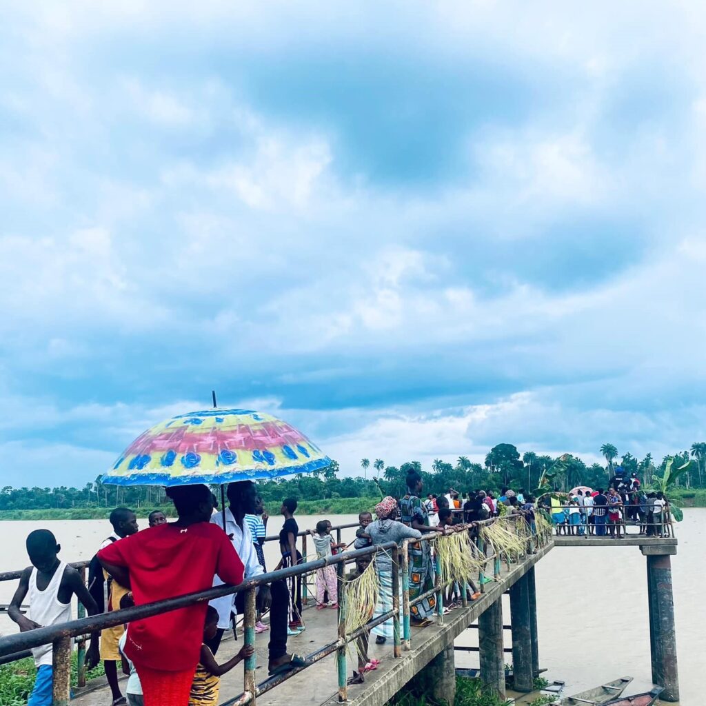 SparkBayelsa- Colorful Umbrella on Busy River Bridge